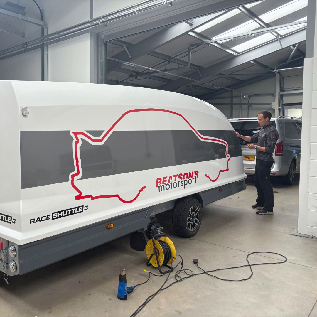 Team member applying Trailer Graphics | Advance Supplies